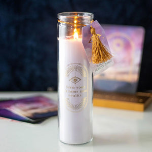 Burning Blackberry Tube Candle with gold tassel tag, creating a cosy and spiritual atmosphere.