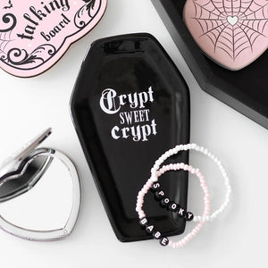 Coffin-shaped ceramic trinket tray with ‘Crypt Sweet Crypt’ slogan styled with gothic accessories.
