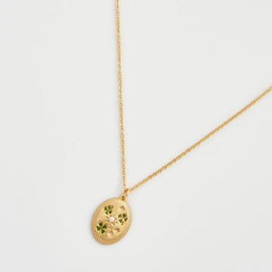 Close-up View: Fable England Four Leaf Clover & Pearl Necklace – gold-plated oval pendant with enamel clovers and pearls.