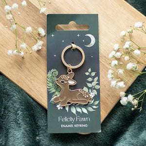 Front view of Felicity Fawn enamel keyring on illustrated backing card with moon and foliage design.