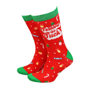 Red and green women’s bamboo socks with bold “Festive As Fuck” slogan and Christmas icons including candy canes, trees, and presents.