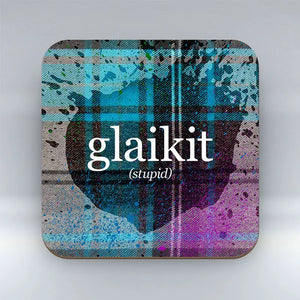 Funny Scottish coaster with “glaikit” text and tartan background.