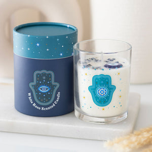 White rose scented candle in glass jar with turquoise Hamsa hand design and matching celestial gift box.