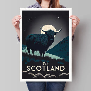 Person holding Highland Cow by Moonlight art print featuring a silhouetted cow and full moon with ‘Visit Scotland’ text.