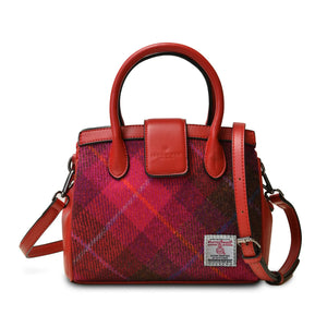 Ladies Harris Tweed tote bag in a red tartan pattern. It has red PU leather handles and an adjustable shoulder strap.