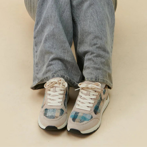 Model wearing Islander Rosie Harris Tweed trainers with matching handbag and relaxed outfit.