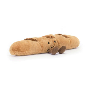 A close-up photo of the Jellycat Amuseable Baguette's golden brown fur and embroidered smile.