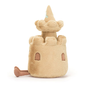 Side View: Time to build! The Jellycat Amuseable Sandcastle with its soft plush texture and playful details is the perfect beach buddy.