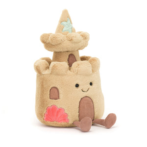 Angled View: Fun in the sun! The Jellycat Amuseable Sandcastle with its textured exterior and embroidered features is ready for imaginative play.