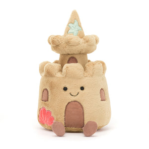 Front View: Build memories at the beach! The Jellycat Amuseable Sandcastle, a soft and cuddly plush toy with a playful face and corduroy flags.