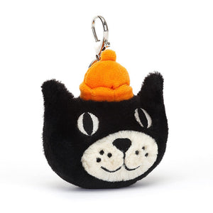 This adorable black and cream kitten bag charm is sure to bring a smile to your face, with stitched facial features and a little orange hat.
