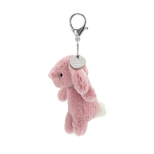 A side view of Bashful Bunny Tulip Bag Charm showing the silver Jellycat tag.