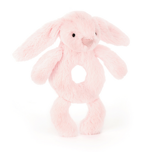 Jellycat Bashful Pink Bunny Ring Rattle at an angle. Soft pink bunny ring rattle with floppy ears and a doughnut-shaped tummy for little hands to shake.