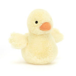  Playful pastel yellow Jellycat Fluffy Duck, perched at an angle, with its soft wings outstretched and a joyful smile.