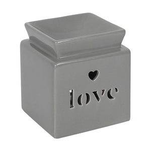 Light grey coloured oil with word love carved into the front with a love heart above. 