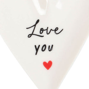 Close up of the painted red heart in the middle of the trinket dish with the words love you printed above. 