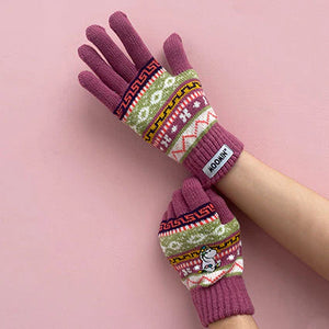 Close-up of Moomin Snorkmaiden Fair Isle gloves worn on crossed arms, showing the full knit design and embroidery.