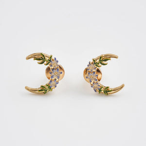 Nightshade Moon gold stud earrings with violet enamel flowers.