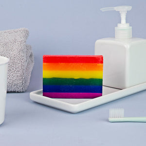 Rainbow soap bar in tropical pride colours on bathroom tray.