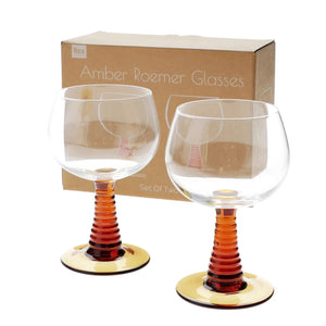 Pair of vintage-style Roemer wine glasses with clear rounded bowls and ribbed amber stems, shown in front of printed cardboard gift box.