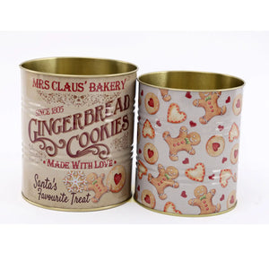 Set of 2 festive gingerbread bakery Christmas tins with vintage-style lettering and gingerbread cookie patterns, perfect for kitchen utensil storage.