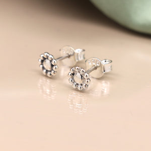 Sterling silver simple flower stud earrings with bobble petals displayed on neutral background.