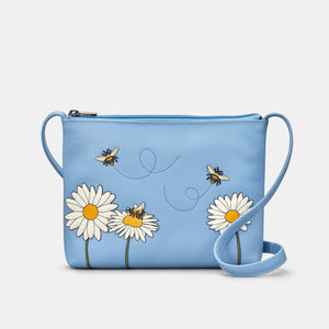 Front view: Soft blue leather crossbody bag with daisy and bumblebee appliqués – Yoshi Bee Happy collection.