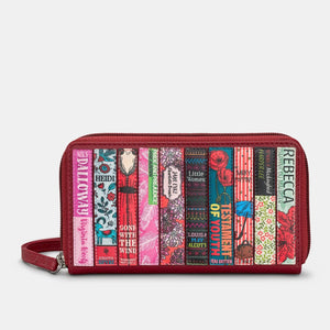 Front view of cherry red leather zip-around purse with colourful book spine appliqué design and detachable wrist strap.