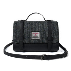 Image of the black and Grey Herringbone Harris Tweed Orkney Satchel. It's made from 100% premium Harris tweed wool. The bag has a structured shape and reinforced top handle. It comes with an adjustable shoulder strap. Inside is a spacious interior lined with soft floral fabric.