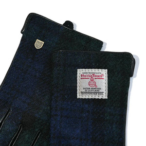 Close up of the top of the ladies gloves showing the Harris Tweed authentication label. 