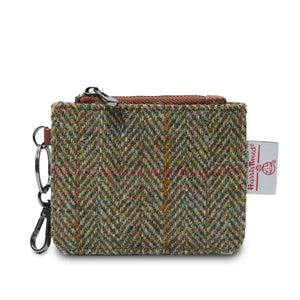 A compact wallet made of PU leather outer and Harris Tweed®, featuring a chestnut herringbone pattern. The wallet has a key chain attachment, three external card slots, and a zip pocket. Its dimensions are L: 11cm H: 7cm.