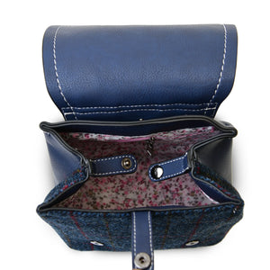 An internal view of the Harris Tweed Navy Tartan backpack showing the inside lining and zipped pocket.