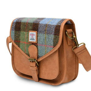 Side view of a Chesnut (Brown) and Blue Tartan Harris Tweed Saddle Bag, showing its sleek and stylish design. The bag features a water-resistant Harris Tweed fabric, an adjustable strap, and a spacious interior.
