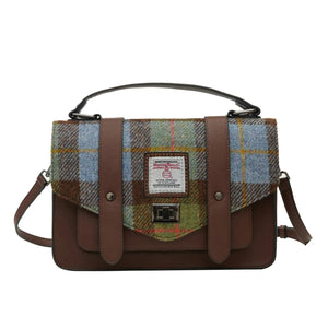 Brown synthetic satchel with a blue, green and brown tartan Harris Tweed design. It has a shoulder strap sitting behind. 