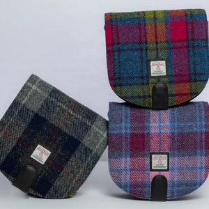 Three Maccessori Harris Tweed Crossbody Bags together. All are tartan, one is grey and blue, one pink and blue and the last one red, green and blue. 