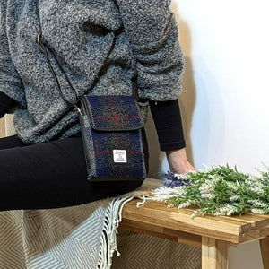 Lady wearing a blue and red tartan Harris Tweed mini crossbody shoulder bag.