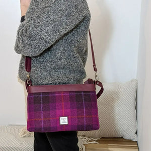 Lady wearing a pink and purple tartan Maccessori Harris Tweed Large Shoulder bag using the strap.