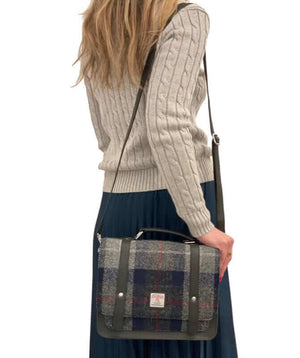 Lady wearing a grey and blue harris tween mini messenger shoulder bag.