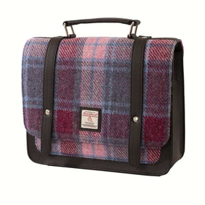 Harris tweed mini satchel shoulder bag in a pink, purple and red tartan. Shown with the top handle and leather fasteners.