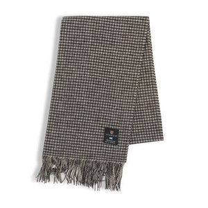 The black and white dogtooth lambswool scarf folded in half.