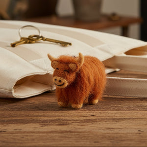Handmade Highland cow felt keyring with shaggy brown fur and embroidered details