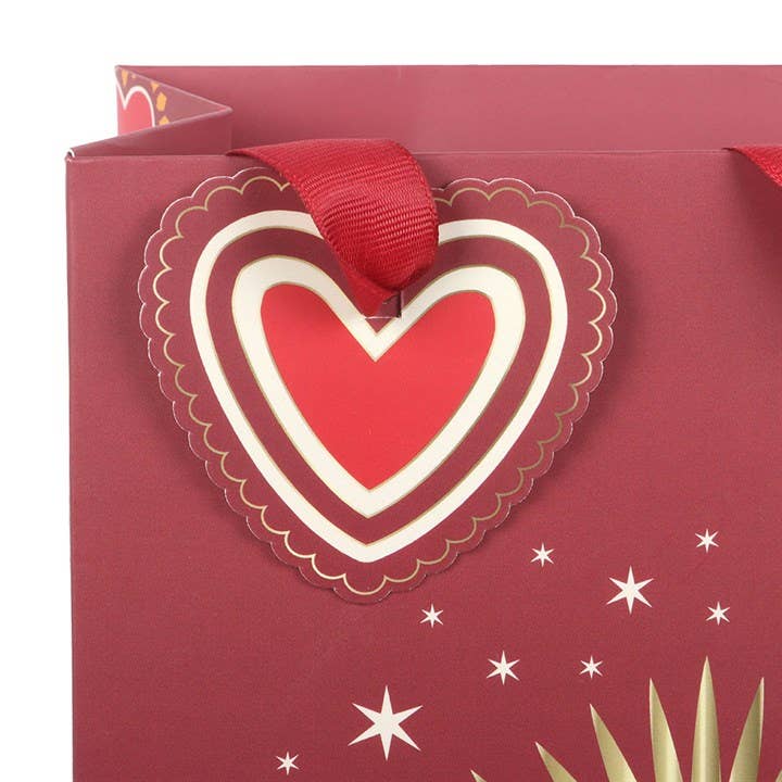 Side view of sacred heart gift bag with handles