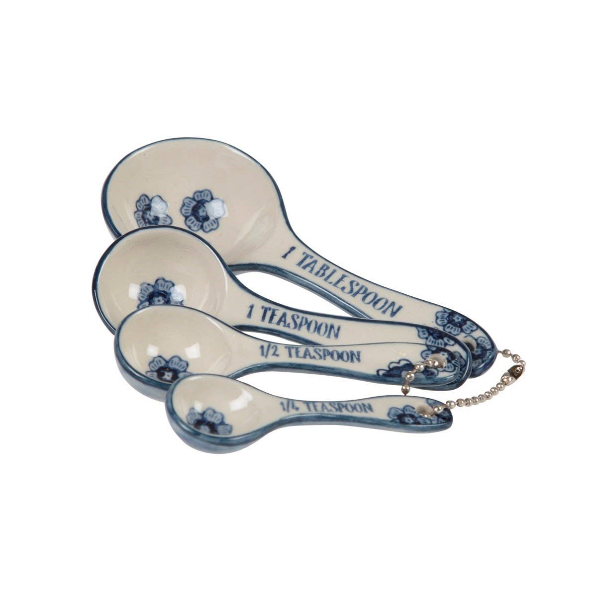 Set of ceramic measuring spoons with blue floral designs on a white background