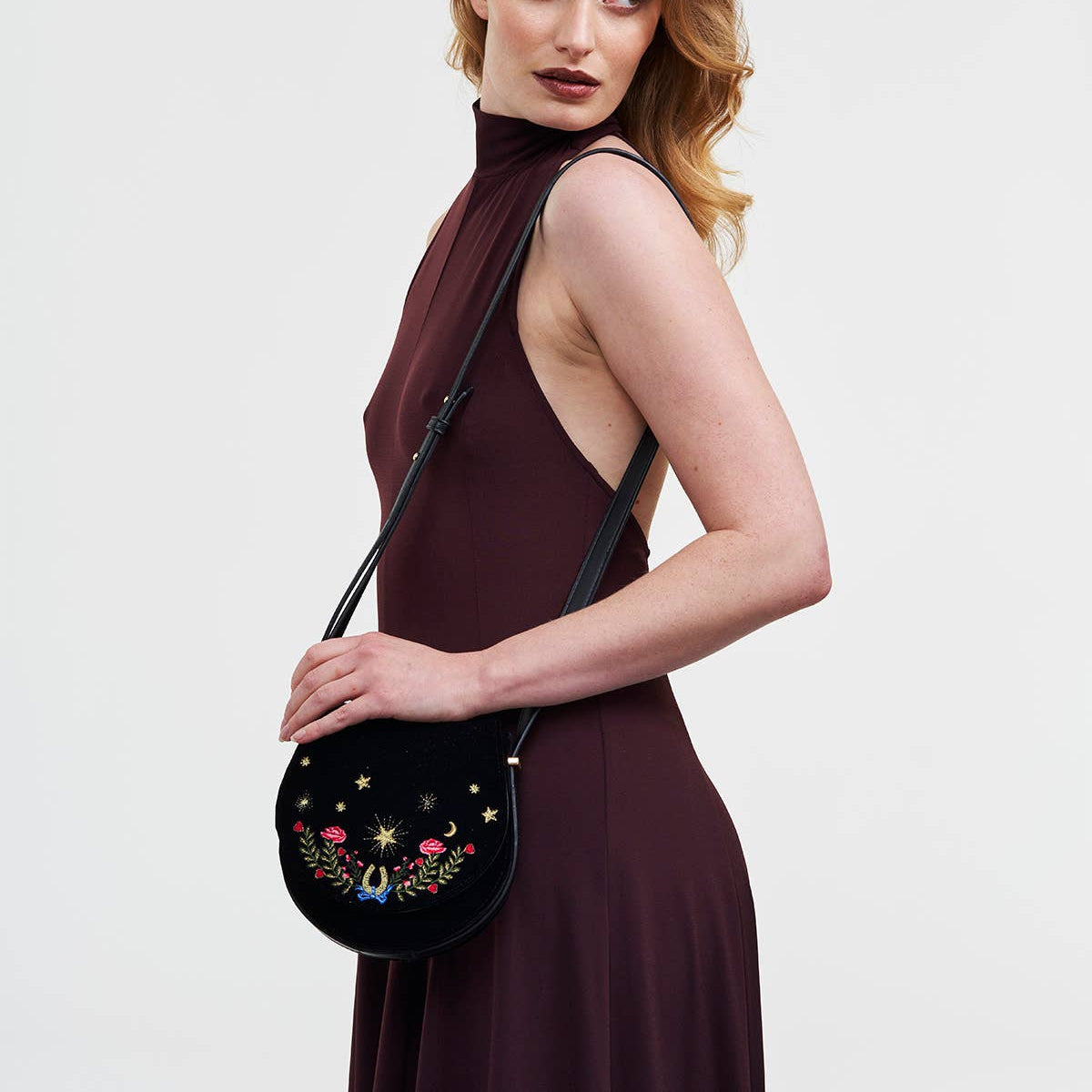 Black Dove and Floral Star Velvet Embroidered Saddle Bag angled view displaying saddle shape silhouette