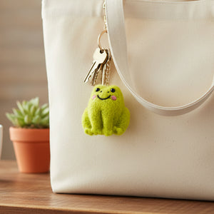 Green felt frog keyring with embroidered eyes and happy smile