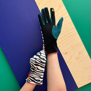 Zebra pattern gloves showing touchscreen friendly fingertip in teal and black.