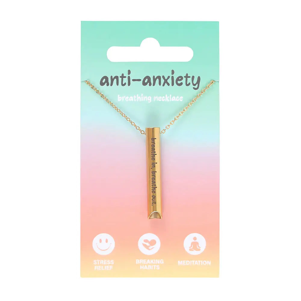Front view of anti-anxiety breathing necklace with gold pendant and chain, displayed on rainbow pastel backing card highlighting benefits like meditation and stress relief.