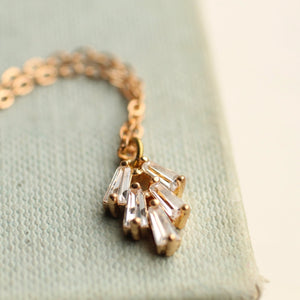 Flat Lay: A detailed shot of the necklace against a neutral background, emphasizing its delicate gold-plated chain and sparkling cubic zirconia.