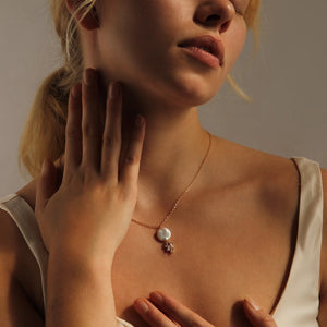 Side angle of the Art Deco Pearl Necklace draped gracefully against the skin, showing its delicate shimmer.