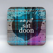 Scottish tartan Ave Jist Sat Doon Coaster with high-gloss finish and bold lettering.